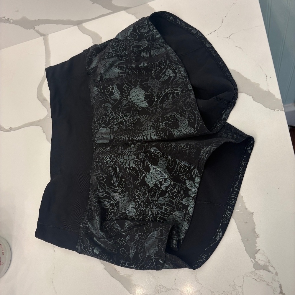 black with reflective floral speed up Lululemon shorts, size 2, 4 in inseam
